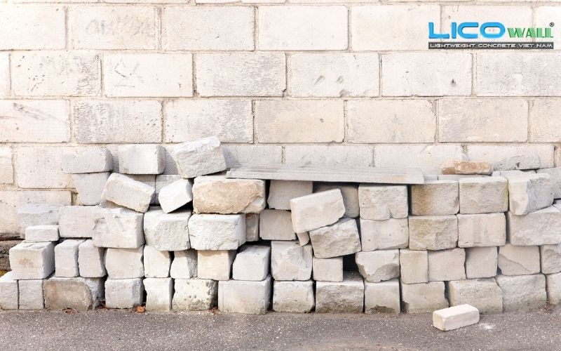 Chồng gạch bê tông khí chưng áp bên cạnh bức tường đã xây xong